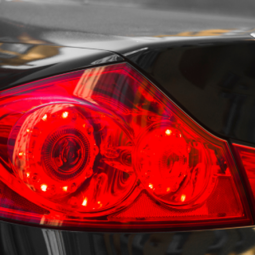 Back of dark car with red rear light