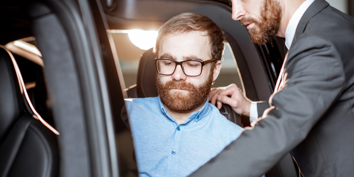 luxury chauffeur opening car door for business client
